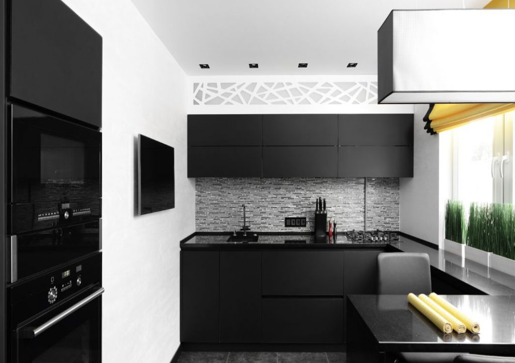 Black kitchen cabinets with white walls