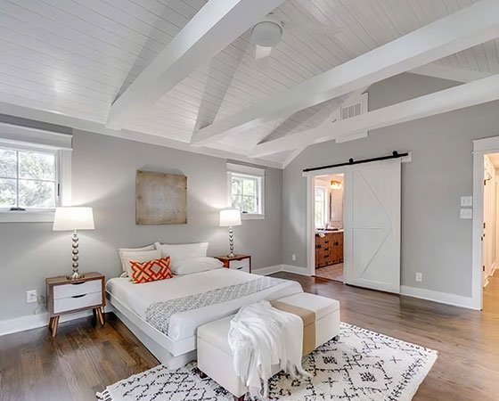 Bedroom addition with barn doors and modern furniture