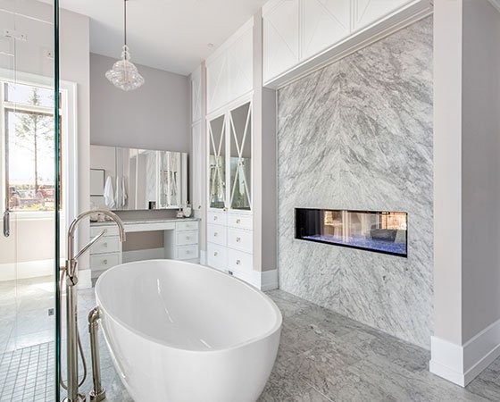 Modern bathroom remodel with freestanding tub and fireplace