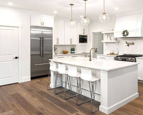 Modern kitchen with white cabinets and hardwood floor